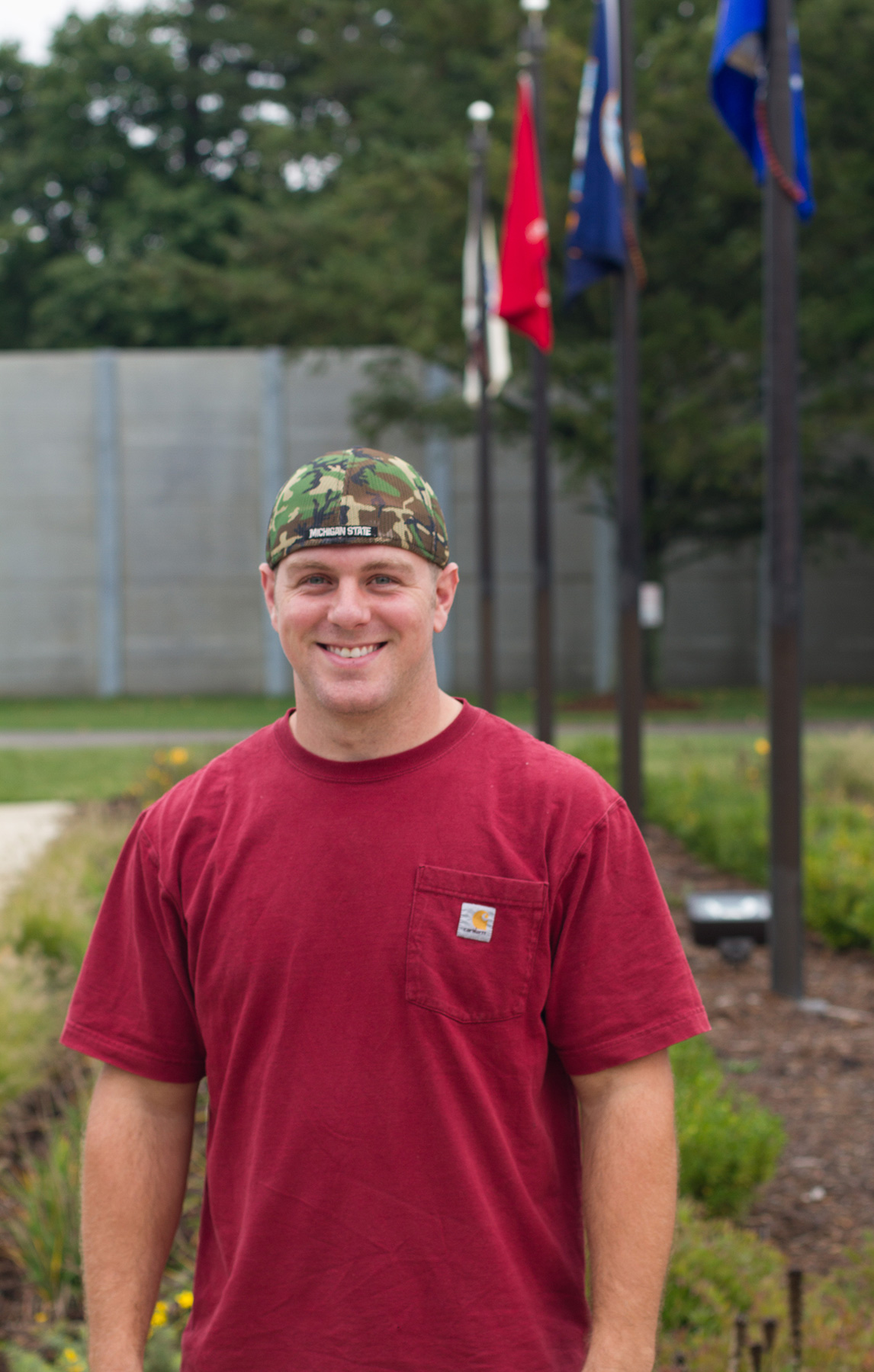 Marine in red t-shirt and camo baseball hat