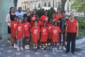 Cinnaire staff with children wearing red girls inc. tshirts