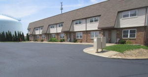 Housing units showing parking spots and a water tower in the background