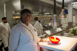 Student in kitchen of Mott's Culinary Arts Training Program