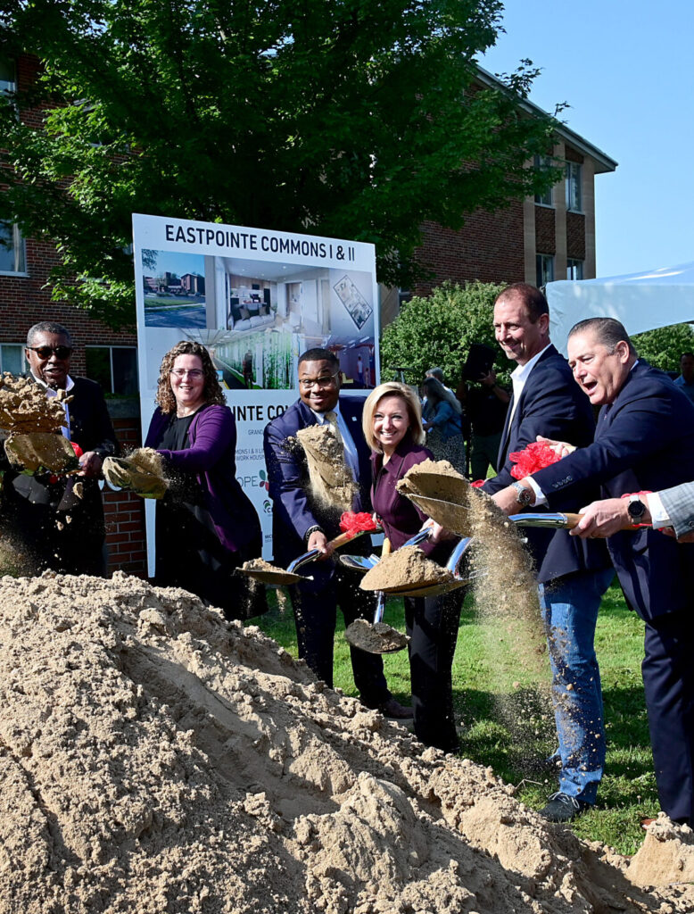 Honored guests and speakers join-in to throw some dirt outside the new Eastpointe Commons complex. United Healthcare is one of the major players in a project that is turning the old, empty Fulton Manor buildings in Grand Rapids into a new housing facility named Eastpointe Commons