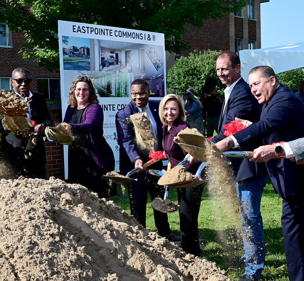 Honored guests and speakers join-in to throw some dirt outside the new Eastpointe Commons complex. United Healthcare is one of the major players in a project that is turning the old, empty Fulton Manor buildings in Grand Rapids into a new housing facility named Eastpointe Commons