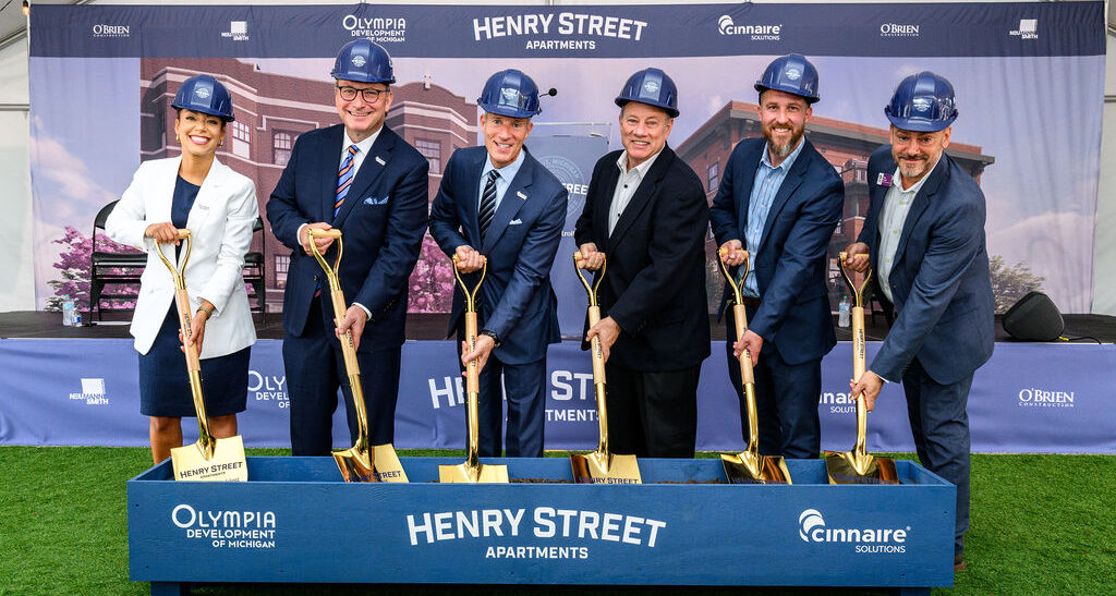 Development partners digging shovels in dirt for Henry St groundbreaking