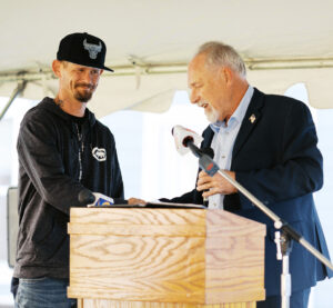 Resident at Andy's Place shaking hands with Mike Hirst, founder