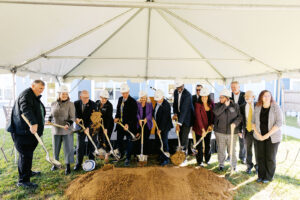 Dignitaries shoveling dirt at the Andy's Place II groundbreaking