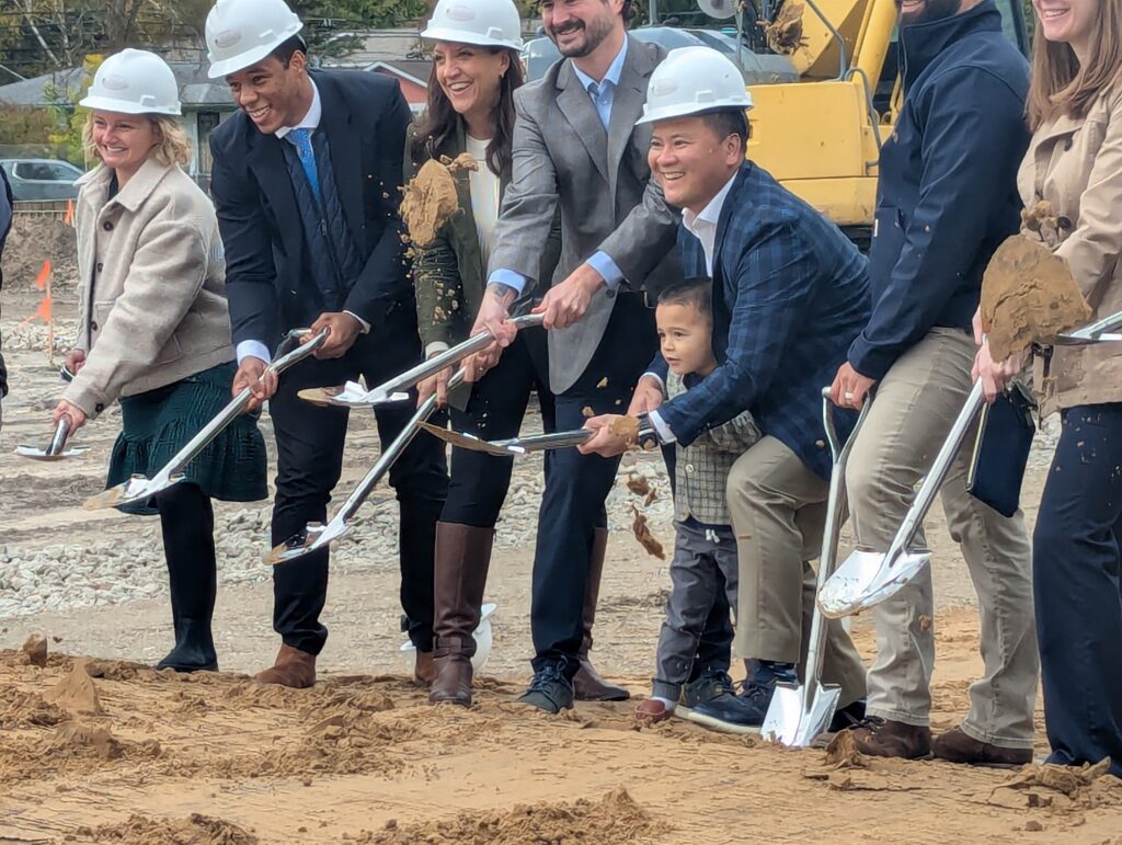 The Dean apartments partners shovel dirt at groundbreaking
