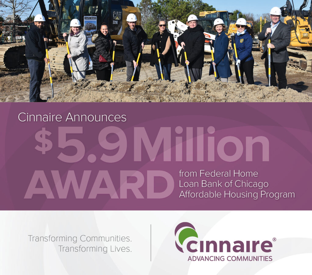Cinnaire staff and partners in hardhats shoveling dirt at groundbreaking