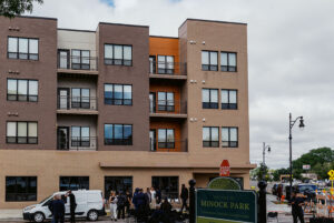 Crowd at grand opening in front of Minock Park apartments