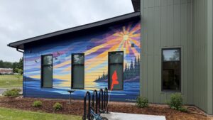 Mural and entrance to affordable housing development in Washburn